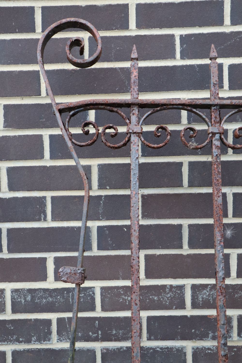 A pair of wrought iron gates, each gate 177cm wide, 193cm high